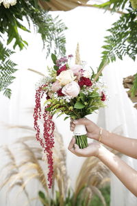 Woman holding bouquet of flowering plant