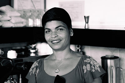 Portrait of smiling woman standing in restaurant