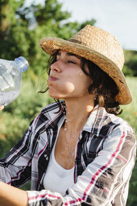 Woman drinking water from bottle