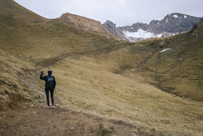 Rear view of woman looking at landscape during winter