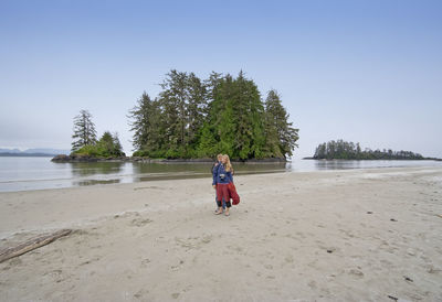 Teenage brother and sister on beach