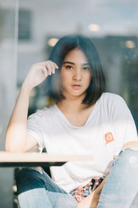 Portrait of young woman sitting outdoors
