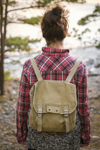 Rear view of woman hiking in forest