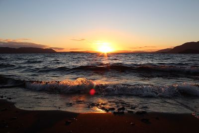 Scenic view of sea against clear sky during sunset