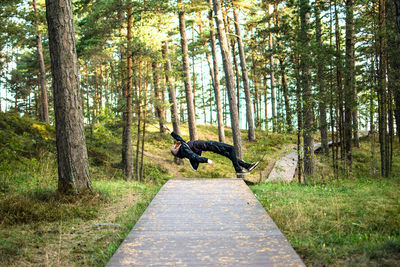 Man falling on footpath in a forest