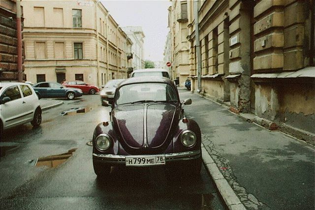 CARS PARKED ON STREET IN FRONT OF RESIDENTIAL BUILDINGS