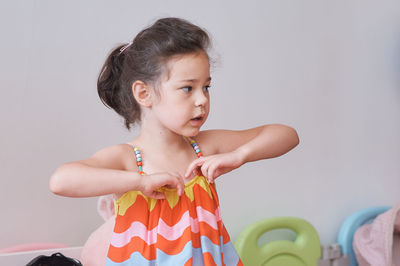 Pretty girl trying on summer outfits with grandmother