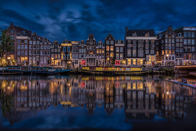 Reflection of illuminated buildings on river at night