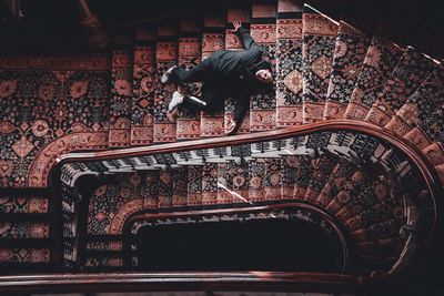 High angle view of man lying on staircases