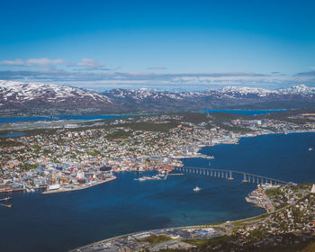 High angle view of city by sea against sky