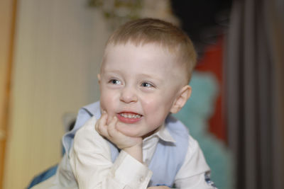 Close-up of smiling boy at home