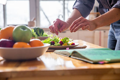 Young and beautiful housewife woman cooking in a white kitchen