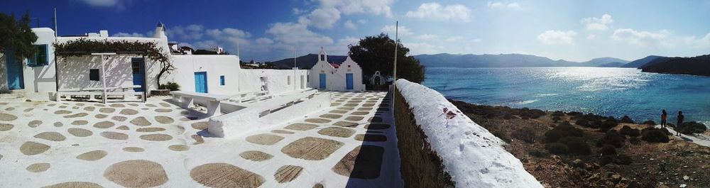 Panoramic view of buildings against blue sky