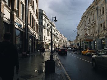 Vehicles on road along buildings