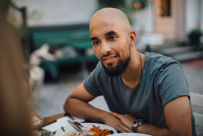 Portrait of young man sitting on table