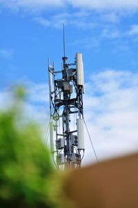 Low angle view of communications tower against sky