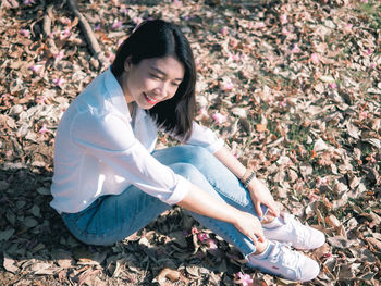 Full length of woman sitting outdoors