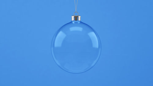 Close-up of electric lamp against blue background