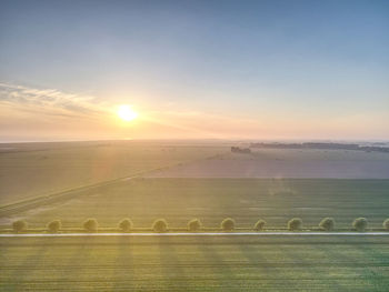 Scenic view of field against sky during sunset