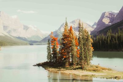 Scenic view of lake and mountains against sky