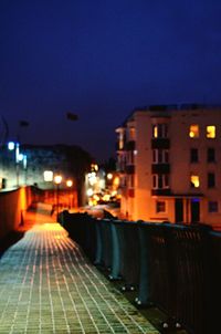 Illuminated city street at night