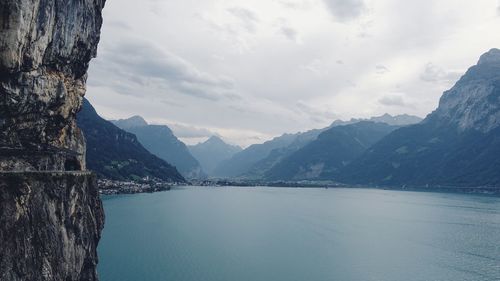 Scenic view of lake and mountains against sky