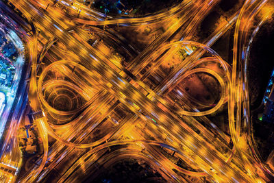 Aerial view of light trails on bridge in city at night