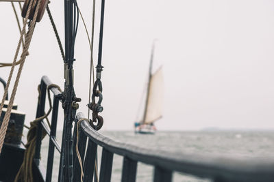 Close-up of railing on a sailboat - ship sailing on ocean in backgroundbackground- selective focus