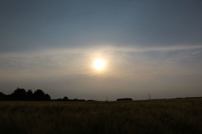 Scenic view of field against sky during sunset