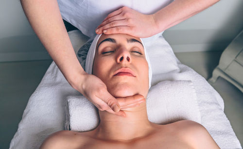 Midsection of woman lying on bed