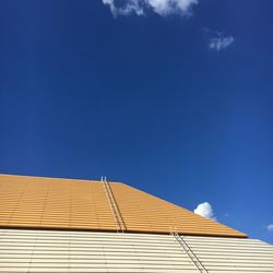 Low angle view of roof against blue sky