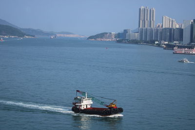 Ship sailing on sea against sky