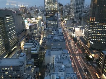 High angle view of illuminated street amidst buildings in city