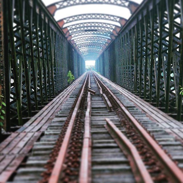 the way forward, diminishing perspective, railroad track, vanishing point, transportation, rail transportation, indoors, metal, public transportation, built structure, architecture, long, surface level, railing, empty, straight, no people, railway track, connection, day