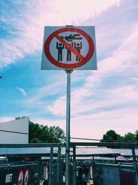 Low angle view of road sign against sky