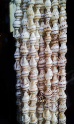 Close up of shell beads hanging in market stall for sale