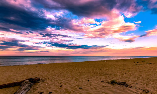 Scenic view of beach against sky during sunset