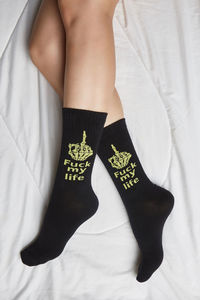 Low section of woman legs on bed at home