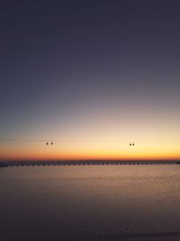 Scenic view of sea against clear sky during sunset