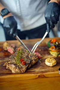 Midsection of man preparing food on table