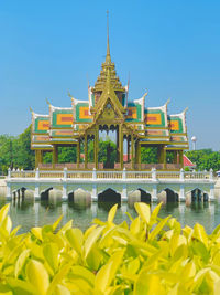 Temple by building against sky