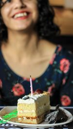Close-up of woman with chocolate cake