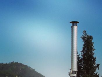 Low angle view of tower against blue sky