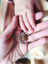 Cropped image of mother and daughter with pendant