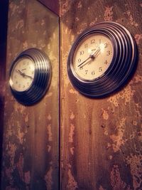 Close-up of clock on white wall