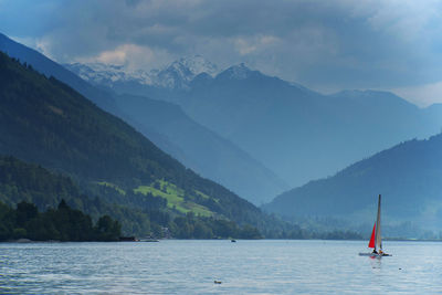 Scenic view of lake and mountains against sky