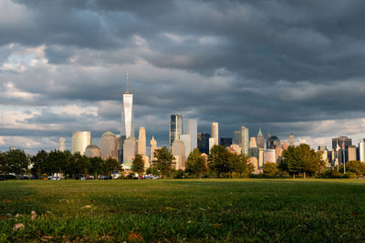 Buildings in city against cloudy sky