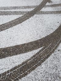 High angle view of tire tracks on snow covered road