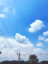 Low angle view of electricity pylon against sky