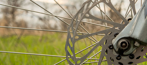 Close-up of bicycle wheel on field